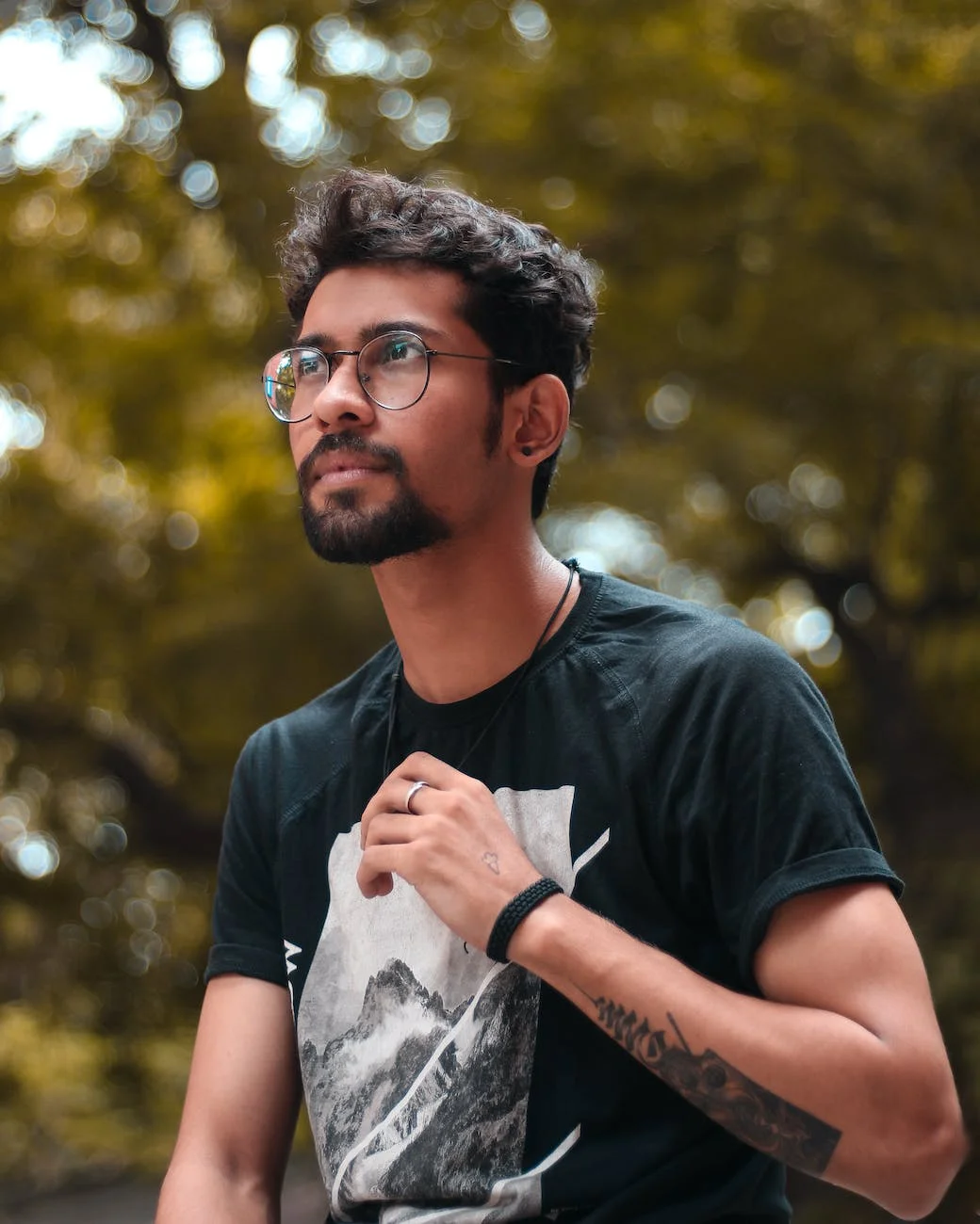 selective focus photography of man standing near trees